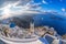 Old Town of Thira on the island Santorini, white church against colorful sunset in Greece