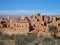 Old town of Tinghir, green palm oasis and rocky Atlas Mountains range landscape in southeastern Morocco