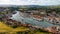 Old town Whitby from the sky, boats on the river, sunny cloudy day