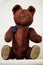 Old toy - a vintage plush brown bear sits on the mantel