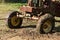 Old tractor being towed by a chain