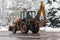 Old tractor cleans snow on city