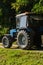 Old tractor with a device for harvesting apples. Boxes for harvesting