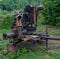 Old tractor equipment on background of a forest