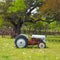 An old tractor in a field with flowers