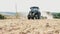 Old tractor plows the field for sowing wheat. Cultivated land work in the field.