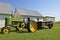 Old tractor pulling a rusty manure spreader