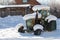 Old tractor under the snow