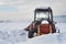 Old tractor under the snow. Snow calamity in transport. Frozen diesel engine.