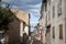 Old traditional French architecture buildings in a pedestrian commercial street of Bourgoin-Jallieu, with the signs of shops