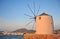 Old traditional hellenic windmill and panorama od Paros