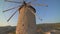 Old Traditional Historic Stone Windmill by the Sea at the Sunset