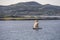 Old traditional sailboat in fjord waters, near Leka island, Norway