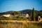 Old traditional stone provencale farmyard in Provence, France with Luberon hill on background in hot summer morning with clear