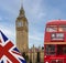 Old traditional vintage London Bus driving by Big Ben in London