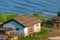 Old traditional white croft cottage with thatched roof, with sea in the bay. Concept of isolated beauty, conservation, building wi