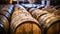 Old traditional wooden barrels with wine, cognac, whiskey, brandy in storage, lined up in a cool and dark cellar