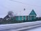 Old traditional wooden russian scenic rustic house in teal color, village of Belarus