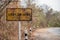 Old traffic signs are rusty USE lOW GEAR and steep warning signs  for trucks on the Mountains