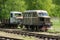 Old train and locomotive. Railroad tracks stretches and green grass and trees. Railway road environment background.