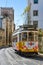 Old tram going through narrow streets in Lisbon