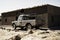 Old truck in front of a refugee camp house