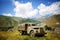 Old truck in a mountainous area against the mountain top of Kazbek in Georgia.