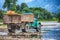 Old truck transports cargo wade across the river.