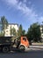 An old truck truck drives along the city's street road