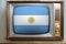 Old tube vintage TV with the national flag of Argentina on the screen, the concept of eternal values, global world trade, politics