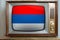 Old tube vintage TV with the national flag of Serbia on the screen, stylish interior of the 60s, the concept of eternal values