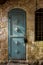 Old turquois metal dirt door with keyhole and rusty metal lockas a beautiful vintage background