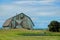 Old turquoise barn retro style with green grass