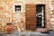 Old Tuscan Wall - Brown door in a medieval stone and brick wall