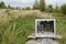 Old TV with broken screen shot from pneumatic weapon against background of green grass and trees. fun for farmers concept - image