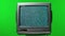 Old TV set in the studio on a green screen of chroma key. White noise effect on the screen. Analog Static Noise texture