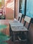 Old twin wooden chair on wooden terrace in front of room with glass window