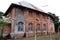 Old two storey brick house, and wooden window.