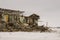 Old two-storied destroyed, ruined and desolated house in winter with snow around. Poverty and misery, North