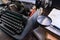 Old typewriter on table, words true story are printed on paper in large size, retro style, magnifying glass, concept of writer,