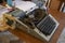 The old typewriter in vintage retro style on a wooden table. Caution - slightly shallow and possibly blurred depth of field