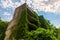 old unfinished stone building overgrown with plants