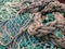 Old and unraveled fishing ropes and nets grouped together for review