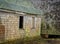 An old unsafe lobster fishing dock house on the verge of collapse