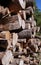 Old, untreated logs are not neatly stacked in a woodpile.