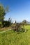 Old unused agricultural machine standing on green grass