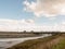 old unused bridge in the distance above estuary stream countryside