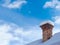 Old, unused chimney covered with snow