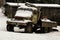 Old unused off-road truck covered with snow