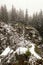 Old unused quarry on the edge of woods covered by snow